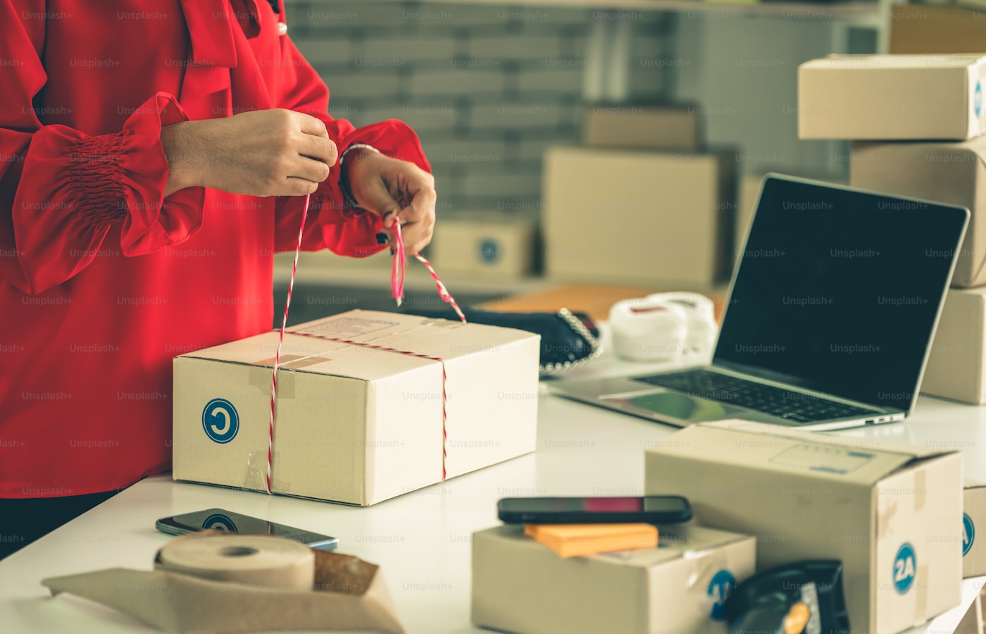 Small business owner preparing ecommerce orders for delivery