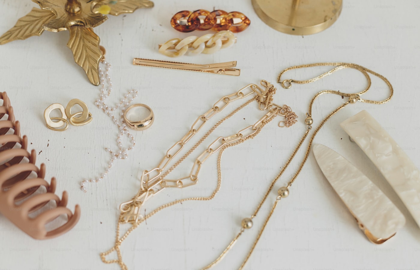 Gold jewellery and accessories arranged on a display surface